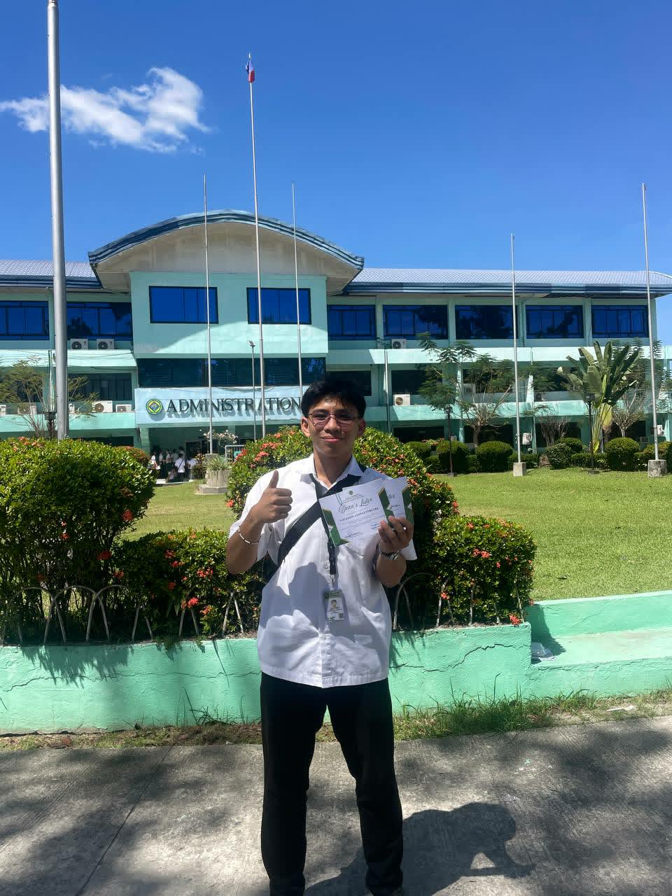 Von holding an academic certificate on the university campus