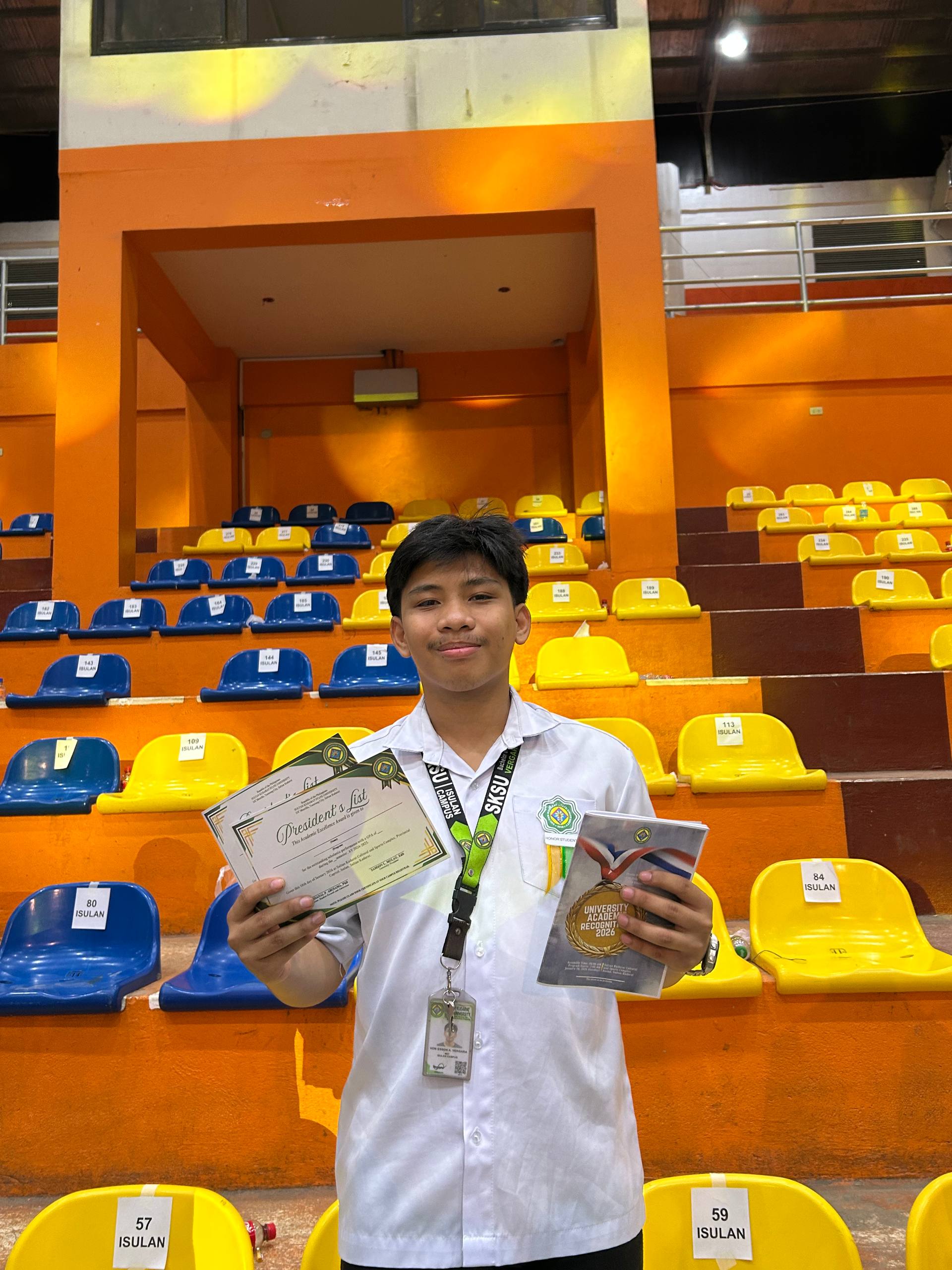 Von holding President's List certificates at the university academic recognition ceremony